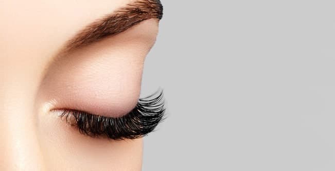 Technicienne posant des extensions de cils